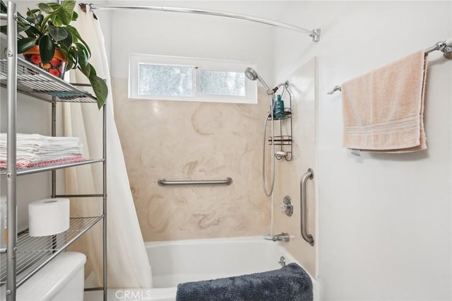 bathroom featuring shower / bath combo with shower curtain and toilet