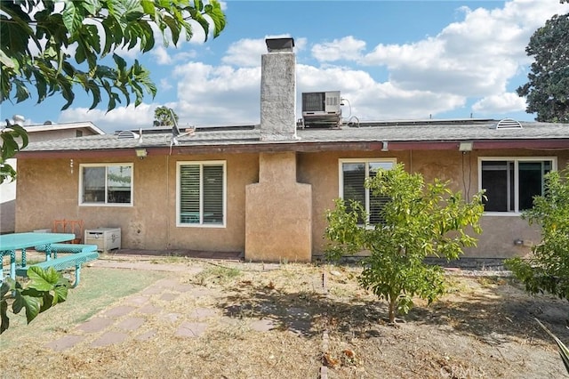 rear view of house featuring cooling unit and a patio area