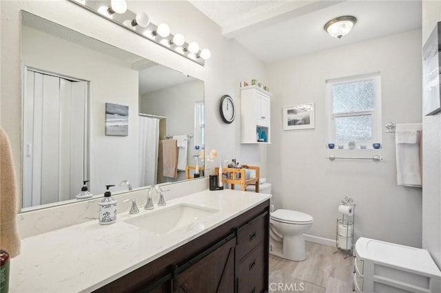 bathroom with hardwood / wood-style floors, vanity, and toilet