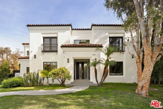 view of front of property with a front lawn and french doors