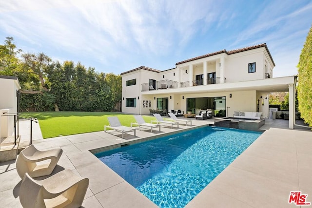 view of swimming pool featuring a lawn, an outdoor living space, a patio, and an in ground hot tub