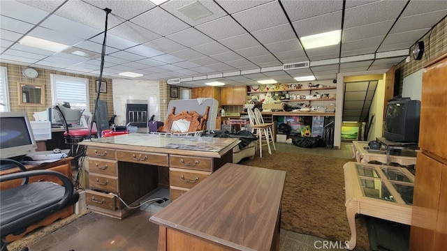 office space with a paneled ceiling