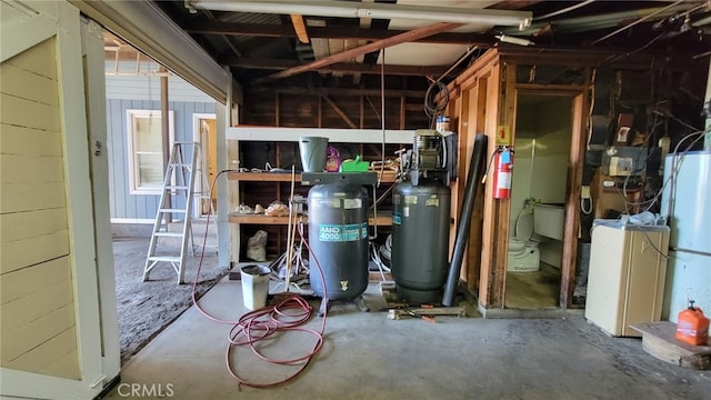 interior space featuring concrete flooring and water heater