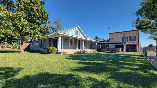 rear view of property with a porch and a yard