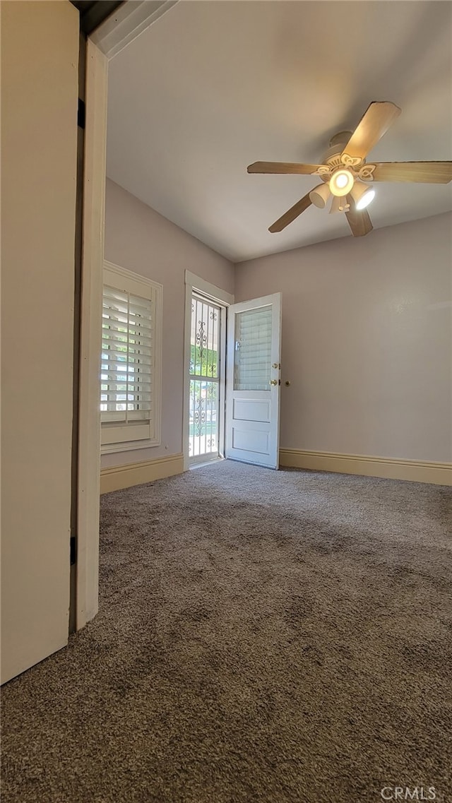 spare room featuring carpet and ceiling fan