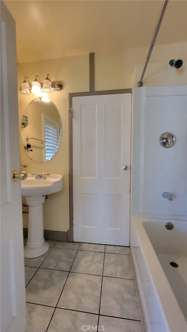 bathroom with tile patterned flooring and tiled shower / bath