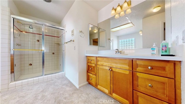 bathroom with vanity and a shower with shower door