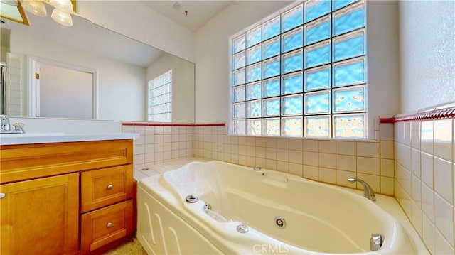 bathroom with a washtub and vanity