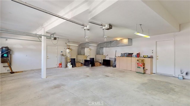 garage with secured water heater and a garage door opener