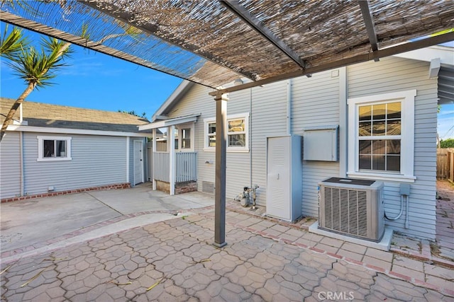 view of patio with a pergola, cooling unit, and an outdoor structure