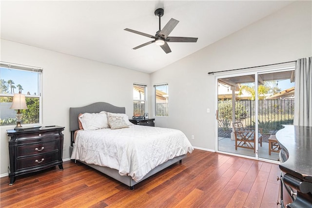 bedroom with access to outside, multiple windows, lofted ceiling, and dark hardwood / wood-style floors