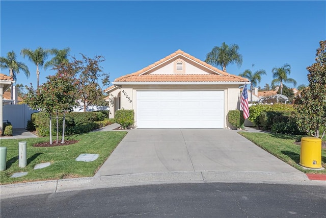 view of front of property featuring a garage and a front yard