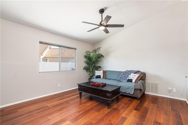 sitting room featuring ceiling fan, dark hardwood / wood-style flooring, and vaulted ceiling