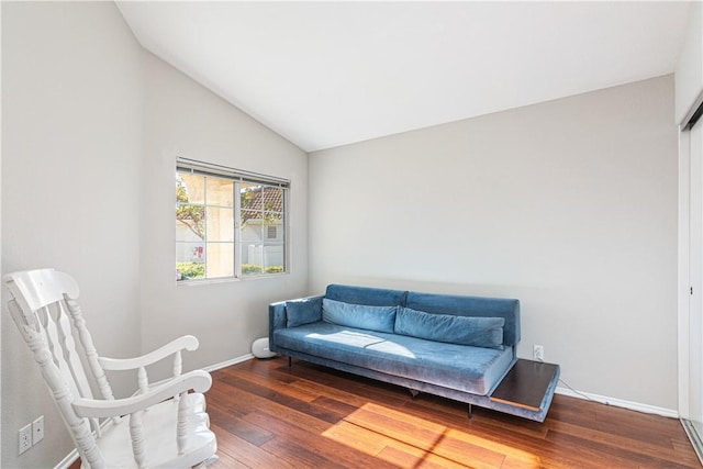 sitting room with hardwood / wood-style floors and vaulted ceiling