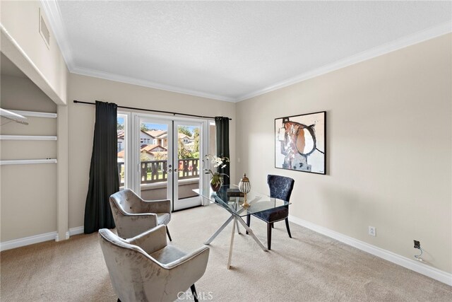 sitting room featuring light colored carpet, ornamental molding, a textured ceiling, and french doors