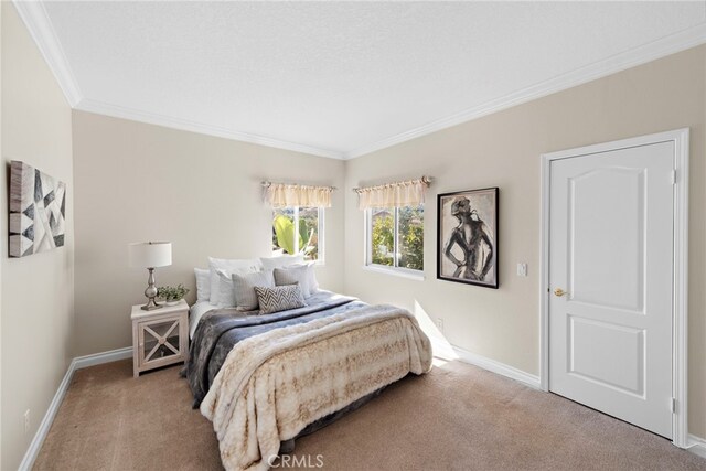 carpeted bedroom with ornamental molding