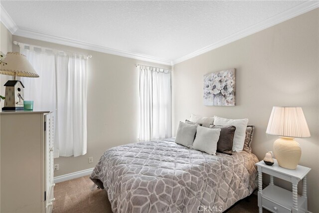 bedroom featuring a textured ceiling, carpet floors, and ornamental molding