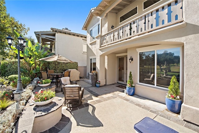 view of patio / terrace with outdoor dining area and a balcony