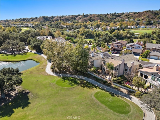 bird's eye view with golf course view, a water view, and a residential view