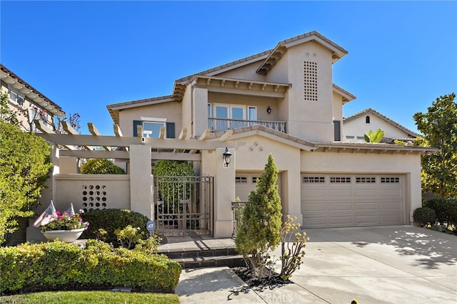 mediterranean / spanish house with driveway, a gate, and stucco siding