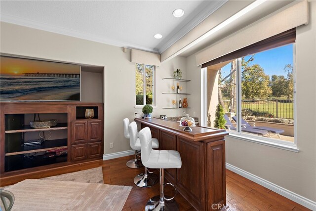 office with hardwood / wood-style floors and ornamental molding