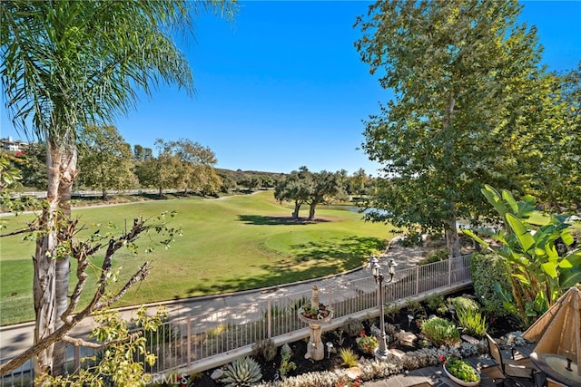 surrounding community with a lawn and fence