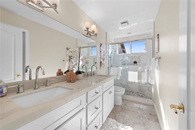 bathroom featuring toilet, visible vents, a sink, and a marble finish shower