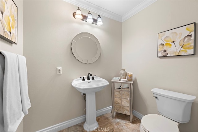 half bathroom featuring baseboards, toilet, and crown molding