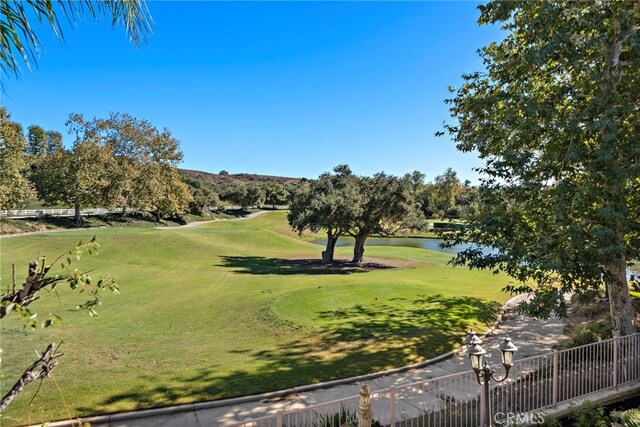 view of property's community with a yard and a water view