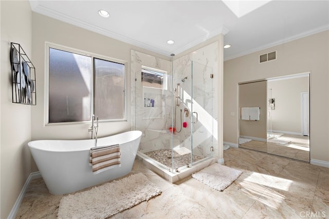 bathroom with ornamental molding and shower with separate bathtub