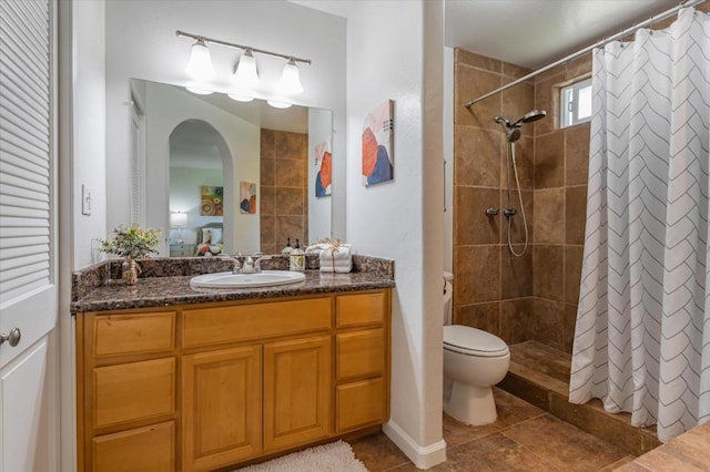 bathroom featuring vanity, toilet, and a shower with shower curtain