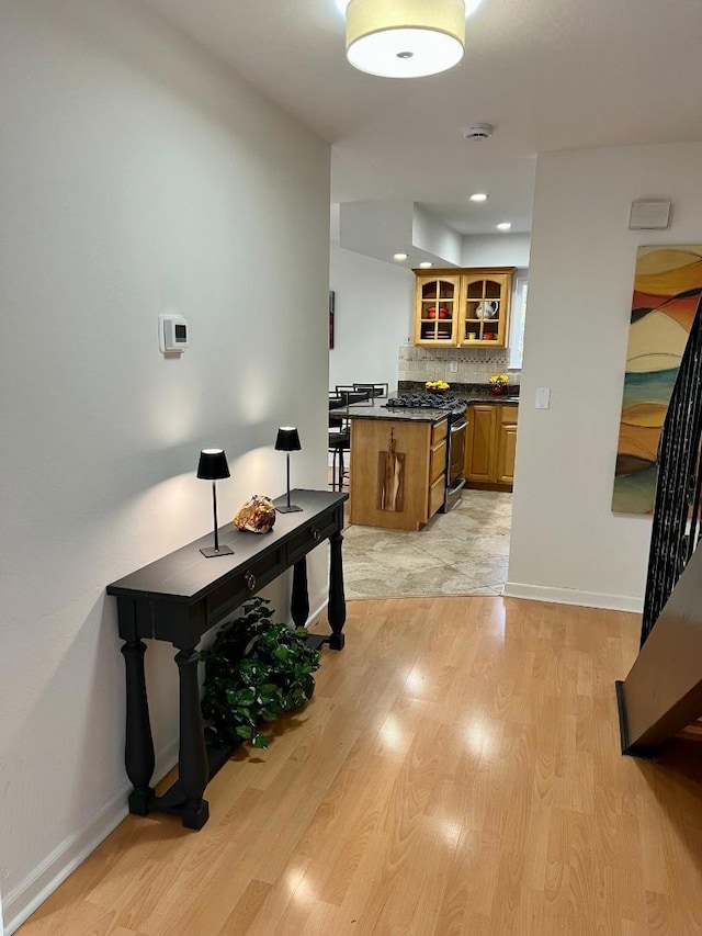 kitchen with light hardwood / wood-style floors and decorative backsplash