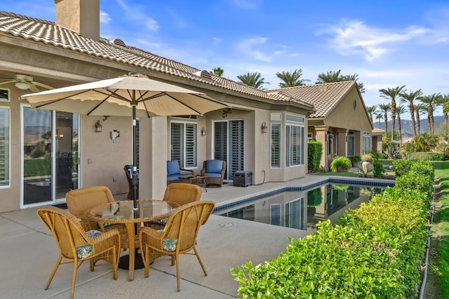 rear view of house with a patio and ceiling fan