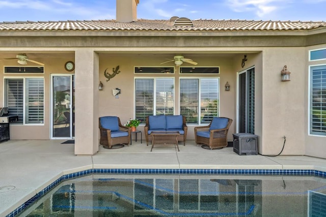 view of pool with an outdoor living space, a patio area, and ceiling fan