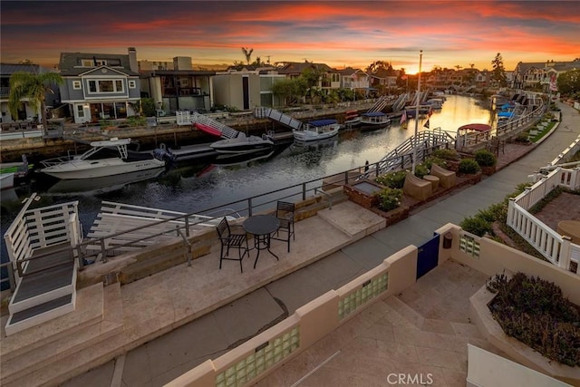 exterior space with a dock and a water view