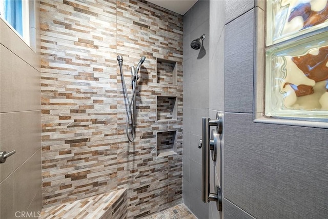 bathroom with a tile shower