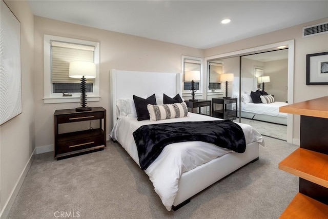 bedroom featuring light carpet and a closet