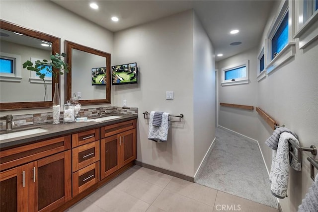 bathroom with tile patterned floors, decorative backsplash, and vanity