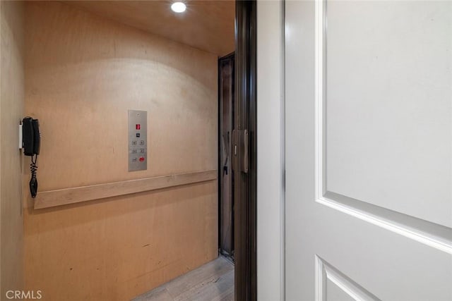 hallway with light hardwood / wood-style flooring