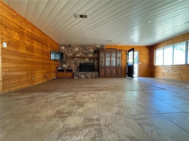 unfurnished living room featuring wood walls, a fireplace, and wood ceiling