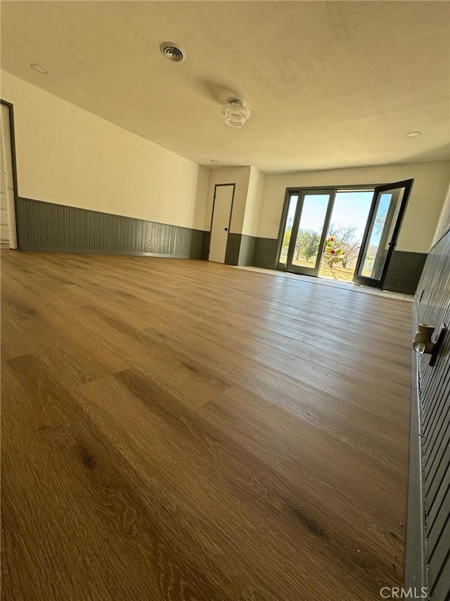 unfurnished room featuring wood walls and dark hardwood / wood-style flooring