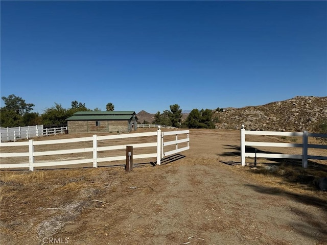 view of yard featuring a mountain view and a rural view