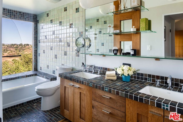 bathroom featuring tile patterned flooring, a tub to relax in, toilet, decorative backsplash, and vanity