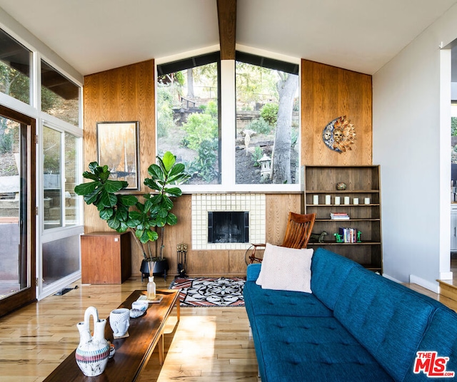 sunroom / solarium with a fireplace and lofted ceiling with beams