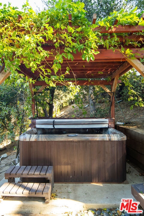 view of patio / terrace featuring a covered hot tub