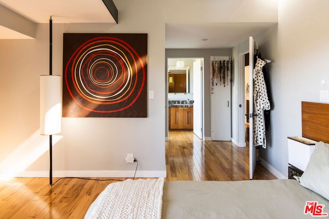 corridor with hardwood / wood-style flooring