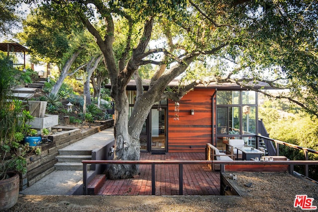 rear view of property with a sunroom