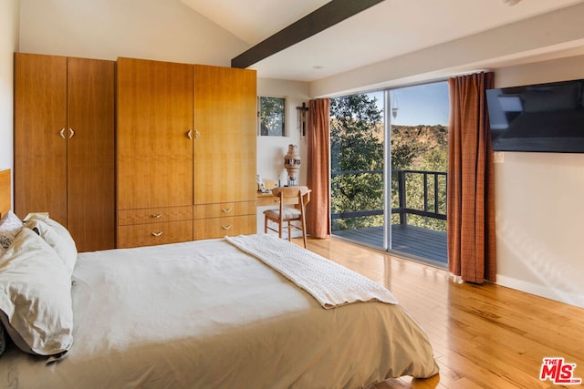 bedroom featuring lofted ceiling, light wood-type flooring, and access to outside