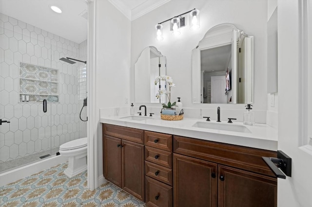 bathroom featuring toilet, vanity, tile patterned flooring, crown molding, and an enclosed shower