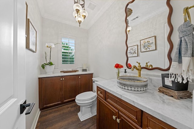 bathroom with toilet, hardwood / wood-style flooring, and vanity